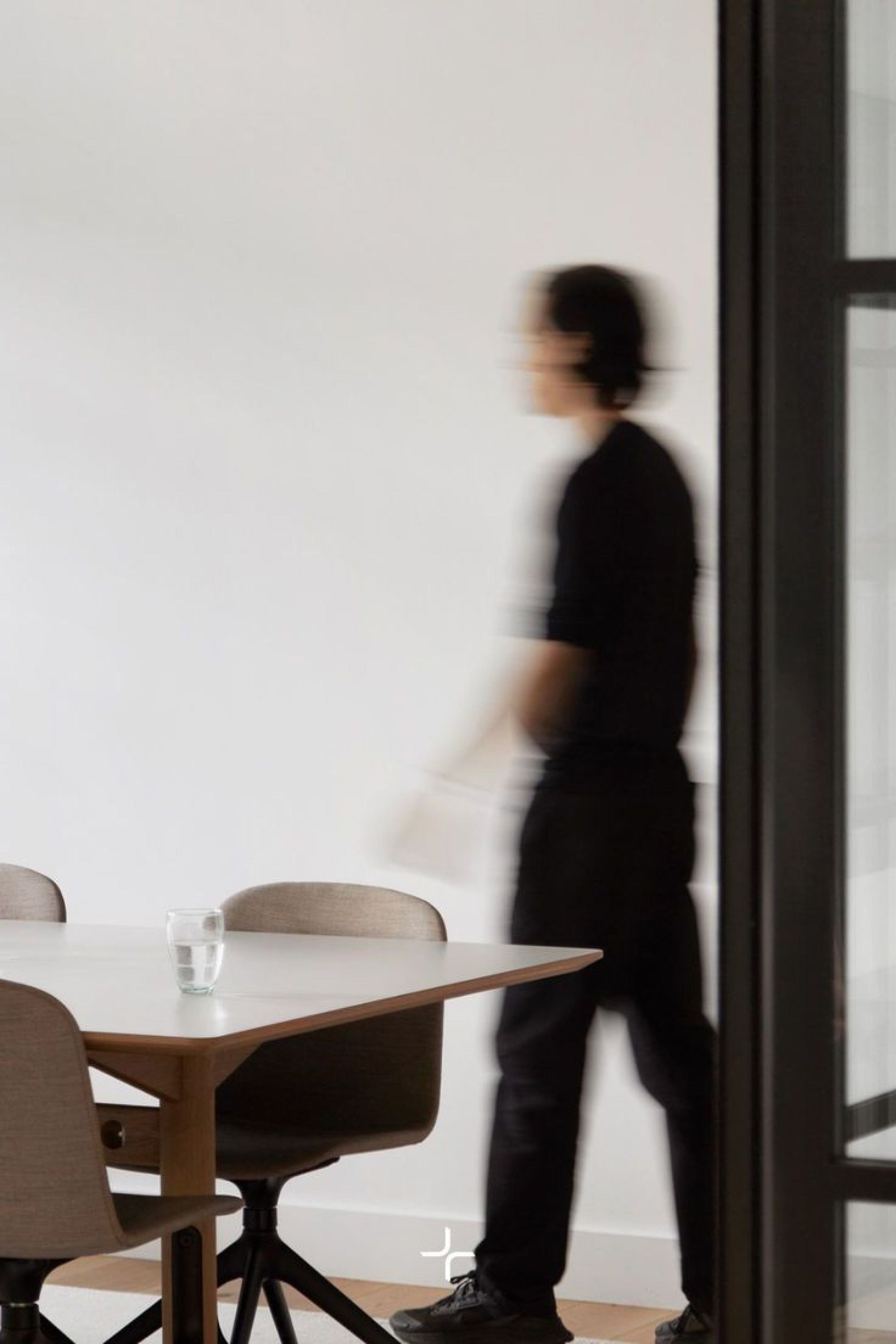 A person walking through a workspace